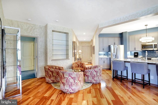 440 Belmont Bay Dr Unit 406, Woodbridge, VA 22191 - living area with light wood-style flooring and wallpapered walls