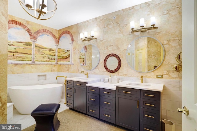 440 Belmont Bay Dr Unit 406, Woodbridge, VA 22191 - full bathroom with tile walls, double vanity, a freestanding bath, and a chandelier