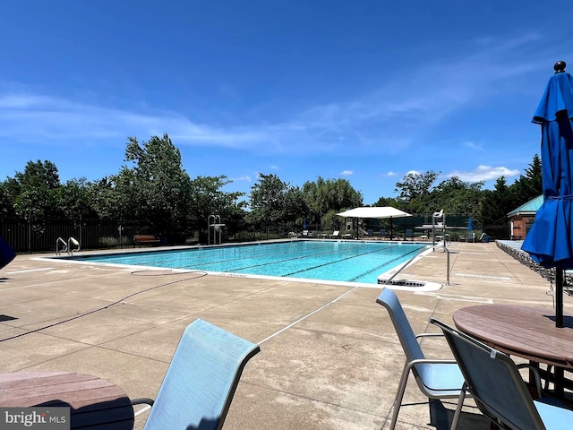 440 Belmont Bay Dr Unit 406, Woodbridge, VA 22191 - community pool with a patio area and view of scattered trees
