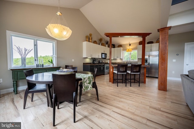311 Summit Woods Dr, Mc Henry, MD 21541 - dining area featuring high vaulted ceiling, light wood-type flooring, and baseboards