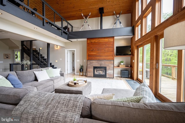 311 Summit Woods Dr, Mc Henry, MD 21541 - living area featuring a towering ceiling, a glass covered fireplace, stairs, and baseboards