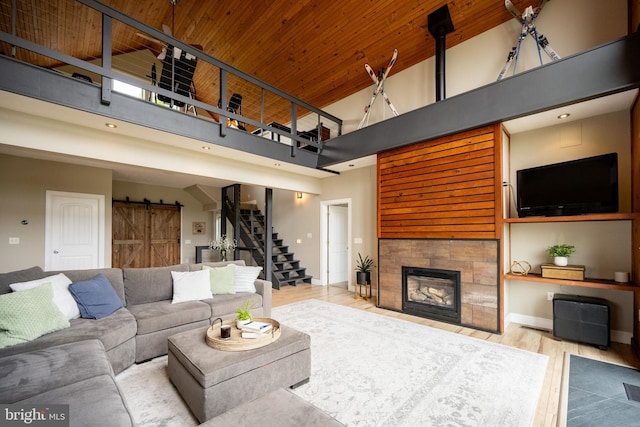 311 Summit Woods Dr, Mc Henry, MD 21541 - living room with a towering ceiling, stairway, a barn door, wood finished floors, and wood ceiling