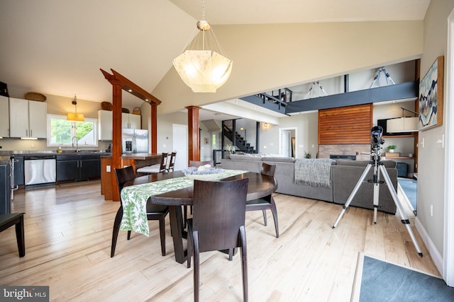 311 Summit Woods Dr, Mc Henry, MD 21541 - dining room with high vaulted ceiling, stairs, and light wood-style flooring