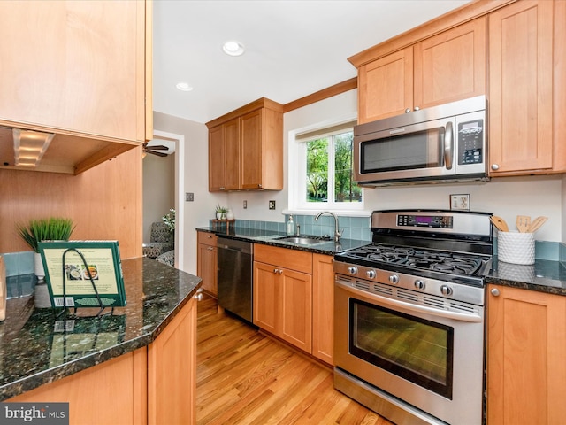 2820 Harris Ave, Silver Spring, MD 20902 - kitchen featuring stainless steel appliances, a sink, light wood-style flooring, dark stone counters, and recessed lighting