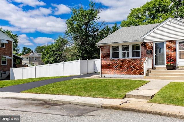 bungalow featuring brick siding and a shingled roof