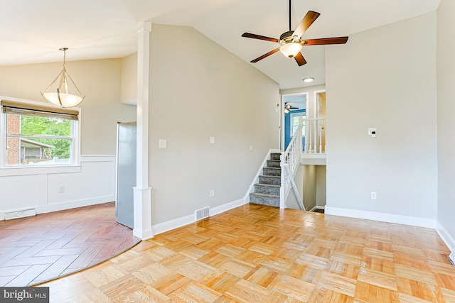 spare room with a ceiling fan, stairs, baseboards, and high vaulted ceiling