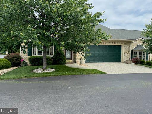12953 Little Hayden Cir, Hagerstown, MD 21742 - view of property hidden behind natural elements featuring a garage and concrete driveway
