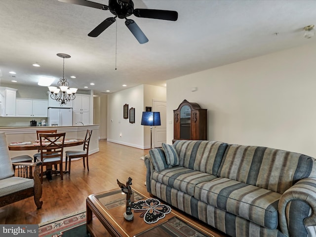 12953 Little Hayden Cir, Hagerstown, MD 21742 - living area featuring light wood-type flooring, recessed lighting, a ceiling fan, a chandelier, and baseboards