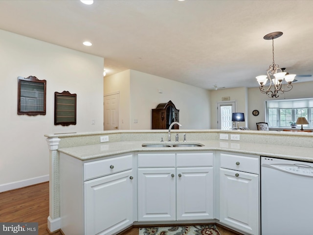 12953 Little Hayden Cir, Hagerstown, MD 21742 - kitchen featuring white dishwasher, a sink, wood finished floors, a chandelier, and white cabinetry