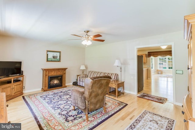 14323 Shiloh Church Rd, Laurel, DE 19956 - living room with ceiling fan, light wood-type flooring, a glass covered fireplace, and baseboards