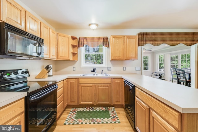 14323 Shiloh Church Rd, Laurel, DE 19956 - kitchen with black appliances, a sink, a peninsula, light brown cabinetry, and light wood finished floors