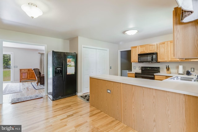14323 Shiloh Church Rd, Laurel, DE 19956 - kitchen featuring black appliances, light brown cabinets, a peninsula, light countertops, and light wood-style flooring