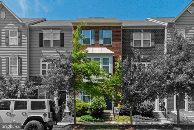 townhome / multi-family property featuring brick siding