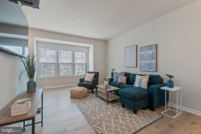 living room featuring wood finished floors and baseboards