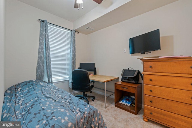 carpeted bedroom featuring multiple windows, a desk, and ceiling fan