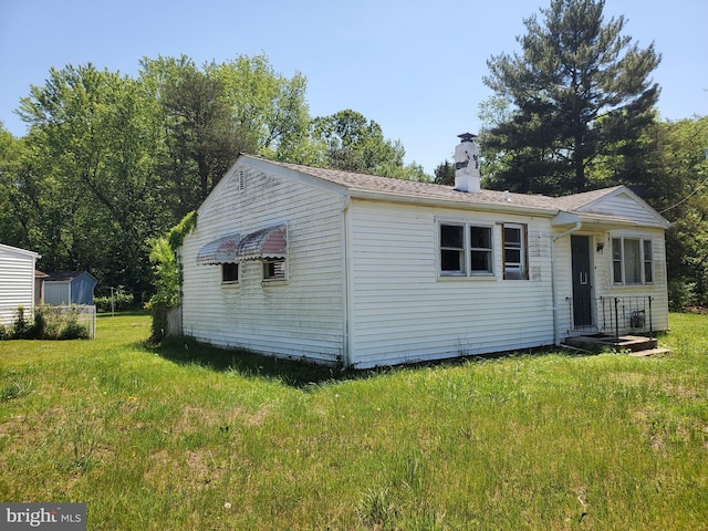 196 Jerrys Ave, Clayton, NJ 08312 - view of front facade with a chimney and a front yard