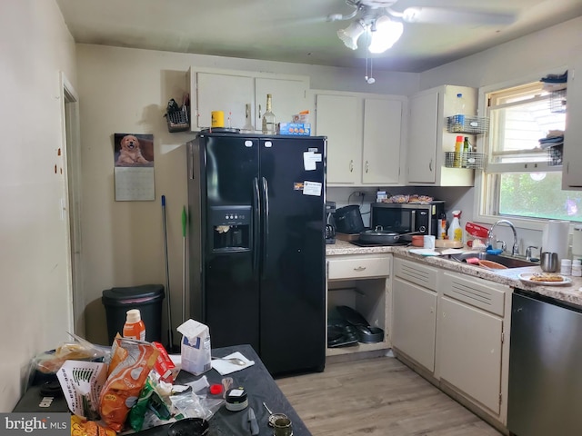 196 Jerrys Ave, Clayton, NJ 08312 - kitchen featuring black fridge, a sink, light countertops, and white cabinetry