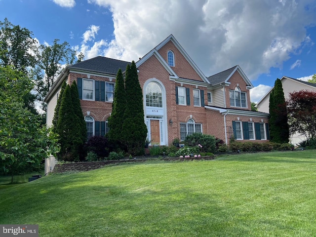 4718 Village Dr, Fairfax, VA 22030 - georgian-style home with brick siding and a front lawn