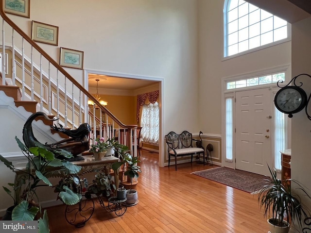 4718 Village Dr, Fairfax, VA 22030 - foyer with stairway, hardwood / wood-style flooring, a towering ceiling, a chandelier, and ornamental molding