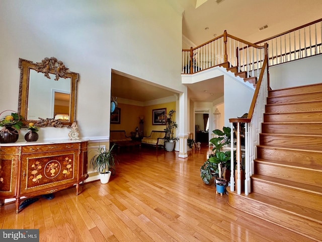 4718 Village Dr, Fairfax, VA 22030 - foyer with a towering ceiling, stairs, wood-type flooring, and ornamental molding