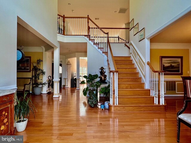 4718 Village Dr, Fairfax, VA 22030 - stairs with a towering ceiling, wood finished floors, and crown molding