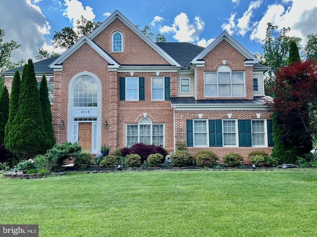 4718 Village Dr, Fairfax, VA 22030 - georgian-style home featuring a front lawn and brick siding