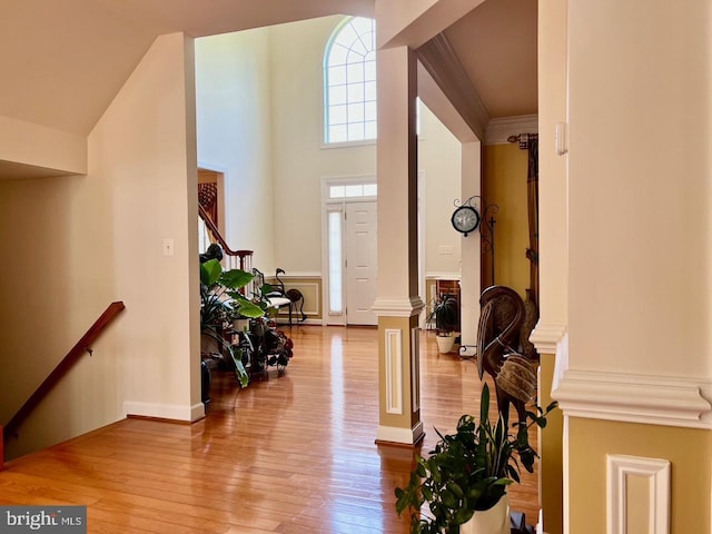4718 Village Dr, Fairfax, VA 22030 - foyer entrance featuring wood finished floors, stairway, ornate columns, and a high ceiling
