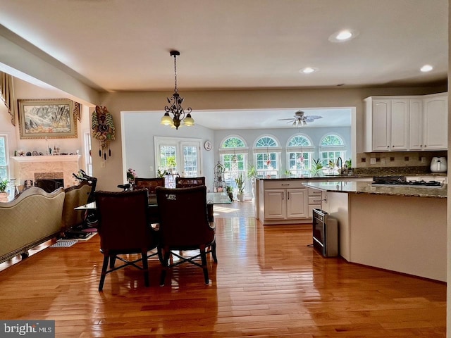 4718 Village Dr, Fairfax, VA 22030 - dining area with wood finished floors, recessed lighting, a ceiling fan, and a fireplace
