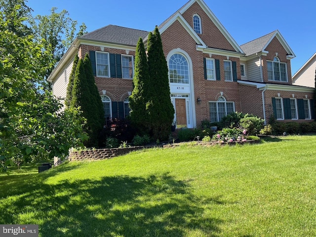 4718 Village Dr, Fairfax, VA 22030 - georgian-style home featuring brick siding and a front yard