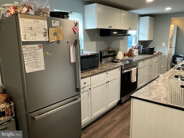 12808 New Row Rd, Mount Savage, MD 21545 - kitchen with appliances with stainless steel finishes, under cabinet range hood, dark wood-style flooring, white cabinetry, and recessed lighting