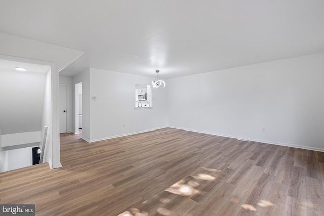 1065 Old Forge Rd, New Castle, DE 19720 - unfurnished living room featuring wood finished floors and baseboards