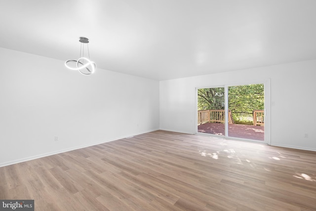 1065 Old Forge Rd, New Castle, DE 19720 - unfurnished room with light wood-type flooring, a chandelier, and baseboards