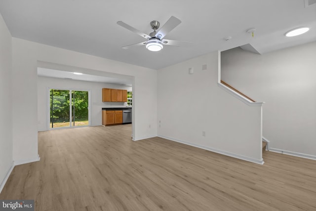 146 Bobbys Branch Rd Unit 71, Millsboro, DE 19966 - unfurnished living room featuring light wood-style flooring, stairs, and baseboards
