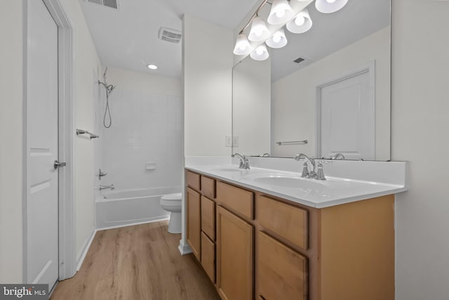 146 Bobbys Branch Rd Unit 71, Millsboro, DE 19966 - bathroom with wood finished floors, double vanity, toilet, and  shower combination