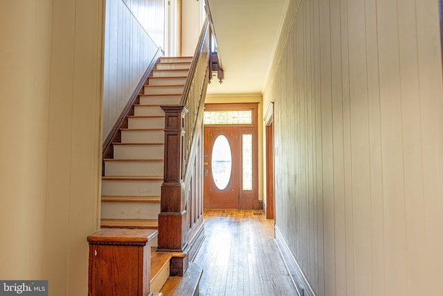 89 Main St N, Kilmarnock, VA 22482 - doorway to outside featuring hardwood / wood-style floors, stairway, and wooden walls
