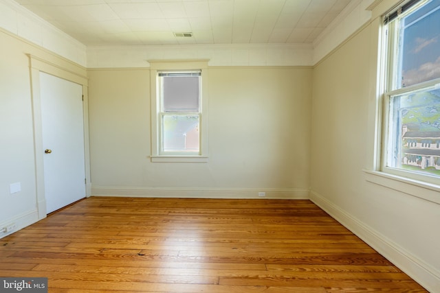 89 Main St N, Kilmarnock, VA 22482 - unfurnished room featuring light wood-style floors, plenty of natural light, crown molding, and baseboards