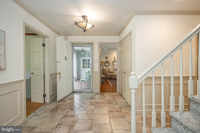 3048 Aquetong Rd, New Hope, PA 18938 - entryway with stairway, crown molding, stone tile flooring, a decorative wall, and a wainscoted wall