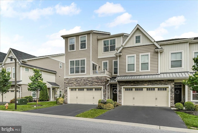 304 Redbud Ln, Kennett Square, PA 19348 - townhome / multi-family property featuring driveway, stone siding, a garage, and a standing seam roof