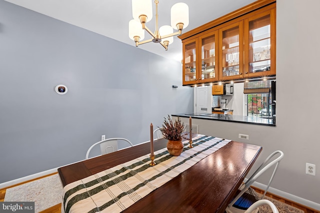 747 Mchenry St, Baltimore, MD 21230 - dining room with a chandelier, baseboards, and wood finished floors