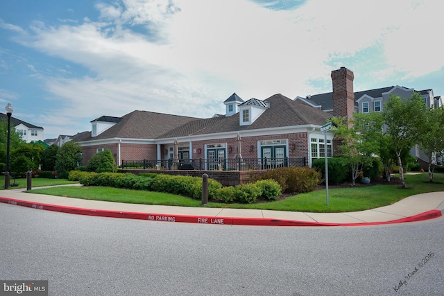 7305 Maplecrest Rd Unit 407, Elkridge, MD 21075 - view of front facade with brick siding, a front lawn, and a chimney