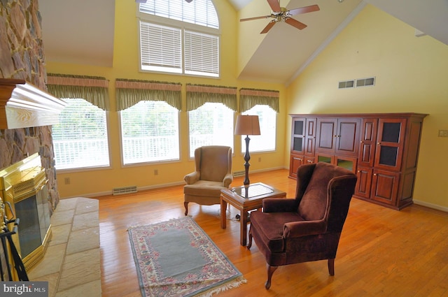 301 Country Club Trl, Fairfield, PA 17320 - living area with a stone fireplace, high vaulted ceiling, a ceiling fan, light wood-style floors, and baseboards