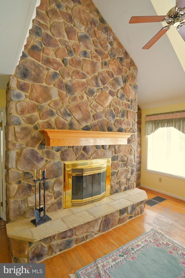 301 Country Club Trl, Fairfield, PA 17320 - unfurnished living room featuring a stone fireplace, vaulted ceiling, wood-type flooring, a ceiling fan, and baseboards