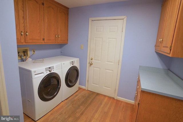 301 Country Club Trl, Fairfield, PA 17320 - washroom featuring cabinet space, washing machine and clothes dryer, light wood-type flooring, and baseboards