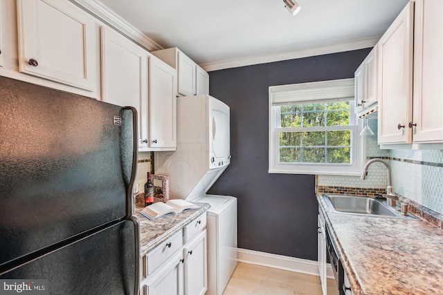 2237 Farrington Ave Unit 301, Alexandria, VA 22303 - washroom featuring stacked washer and clothes dryer, baseboards, ornamental molding, and cabinet space