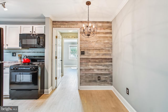 2237 Farrington Ave Unit 301, Alexandria, VA 22303 - kitchen featuring black appliances, wood walls, white cabinets, a chandelier, and light wood finished floors