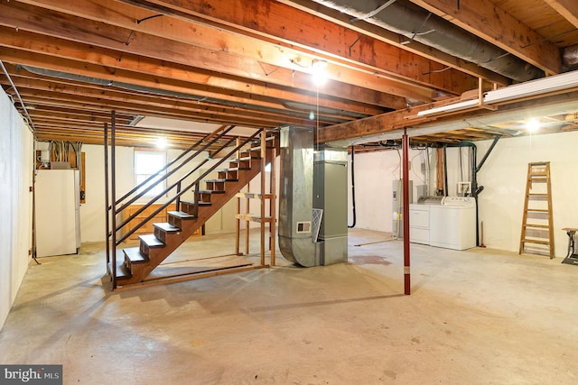 2070 Farragut Dr, Stafford, VA 22554 - unfinished basement featuring independent washer and dryer, stairs, electric water heater, heating unit, and freestanding refrigerator