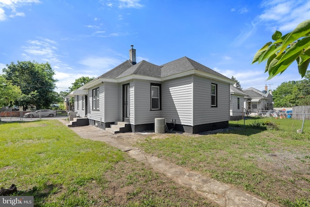 311 W Washington St, Paulsboro, NJ 08066 - view of property exterior with entry steps, a shingled roof, and a chimney