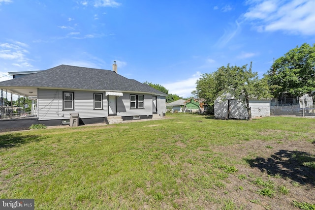 311 W Washington St, Paulsboro, NJ 08066 - rear view of property featuring a lawn and a shingled roof