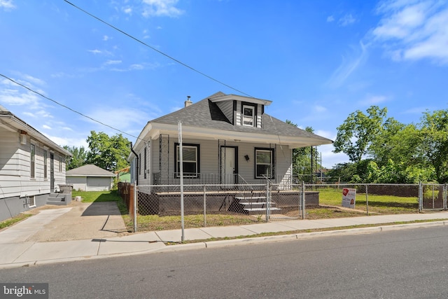 311 W Washington St, Paulsboro, NJ 08066 - view of front of property with a porch, a fenced front yard, a chimney, roof with shingles, and a gate