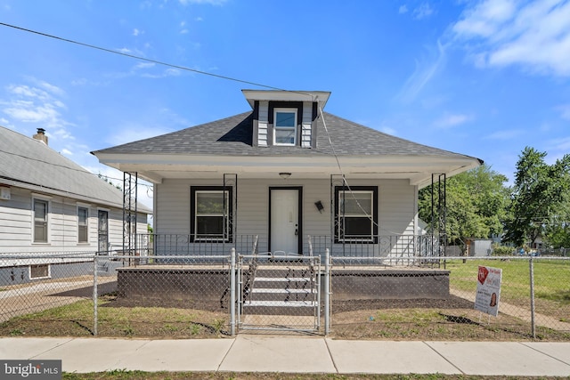 311 W Washington St, Paulsboro, NJ 08066 - bungalow-style home with covered porch, a gate, a fenced front yard, and a shingled roof
